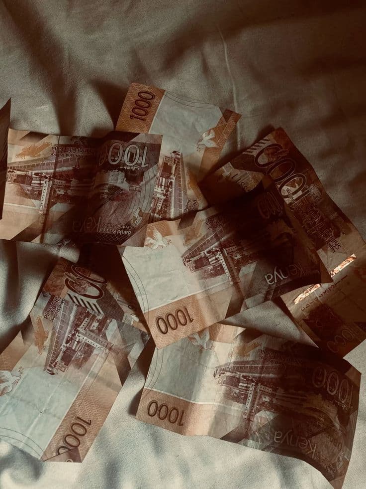 Woman looking at her phone's mpesa message - So utadoo? Utaretaliate!